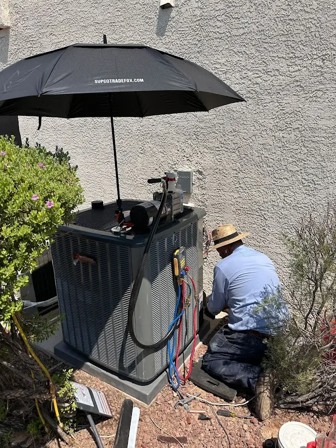 HVAC technician performing outdoor AC maintenance in North Caldwell